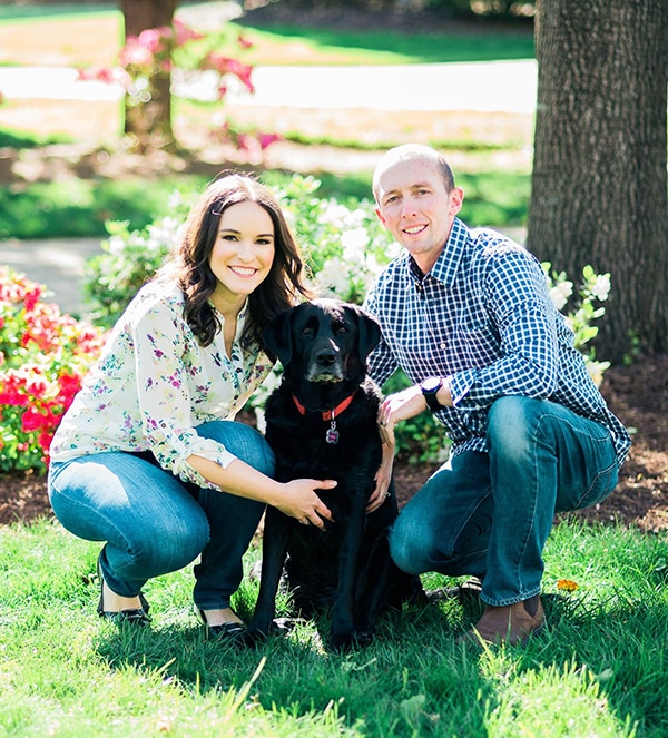 lindsay, her husband and black lab outside