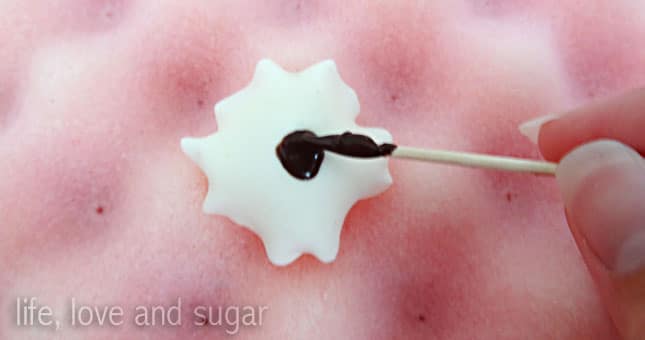 adding chocolate to fondant flower