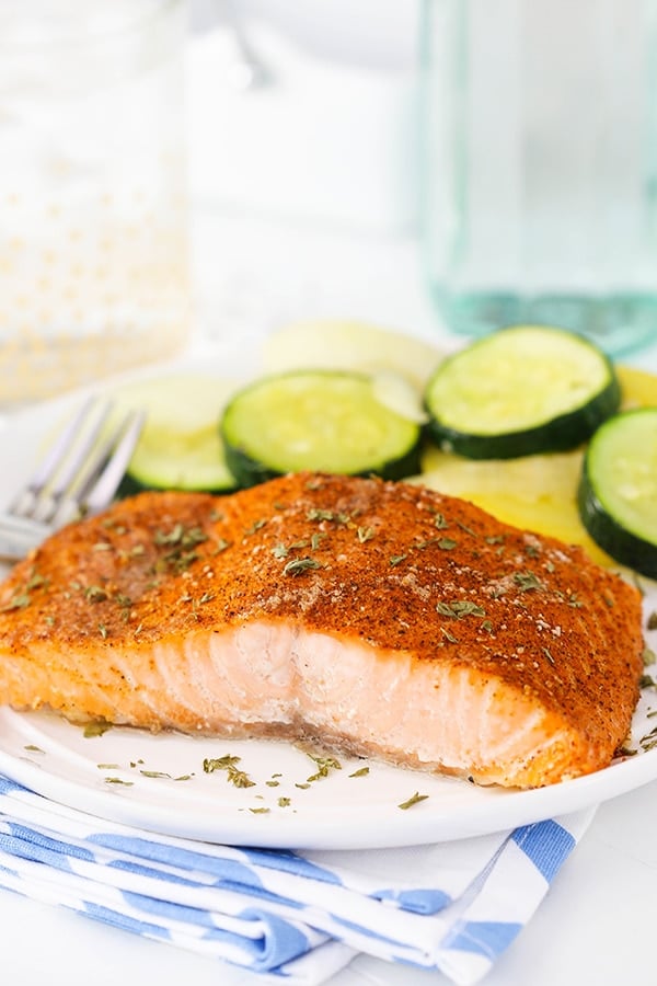 Easy Creole Salmon on white plate with side of veggies