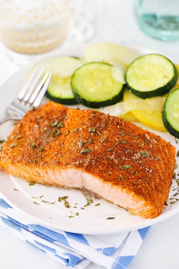 image of Easy Creole Salmon on white plate with veggies and fork