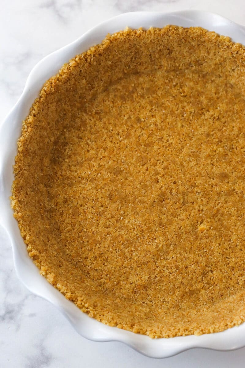 crust pressed into white ruffle pie plate