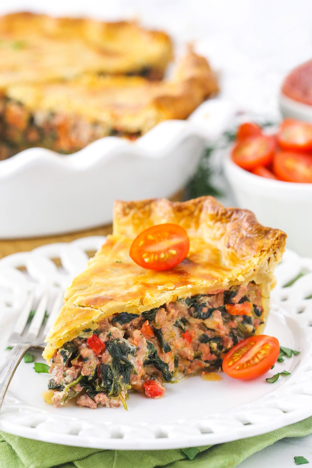 A slice of homemade meat pie on a white plate