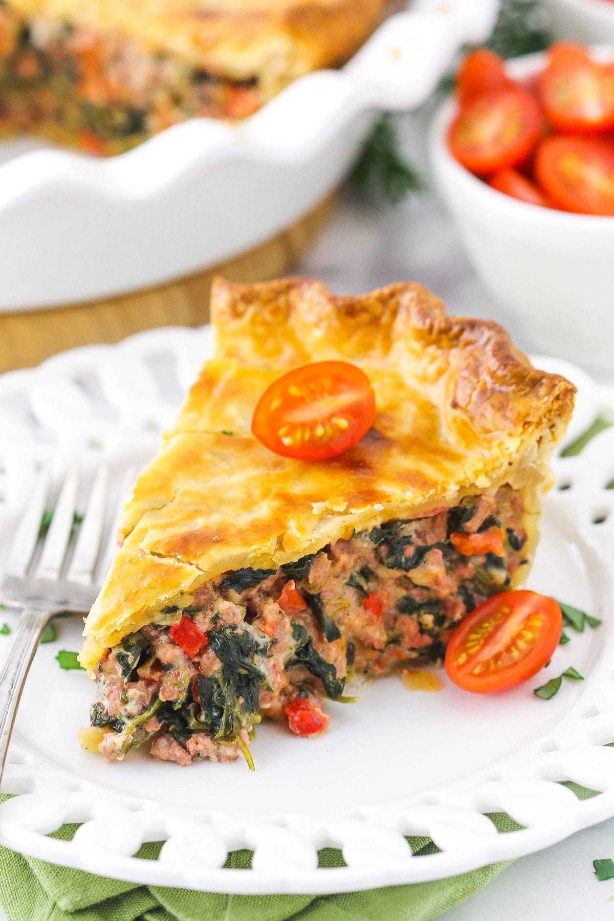 A slice of homemade meat pie on a white plate