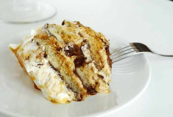 slice of Caramel Macchiato Tiramisu with Nutella on a white plate with a fork