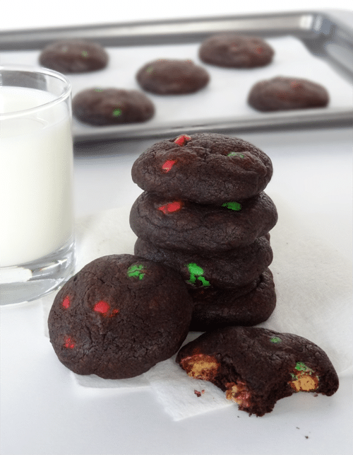 Chocolate Peanut Butter M&M Cookies stacked and one cookie is missing a few bites