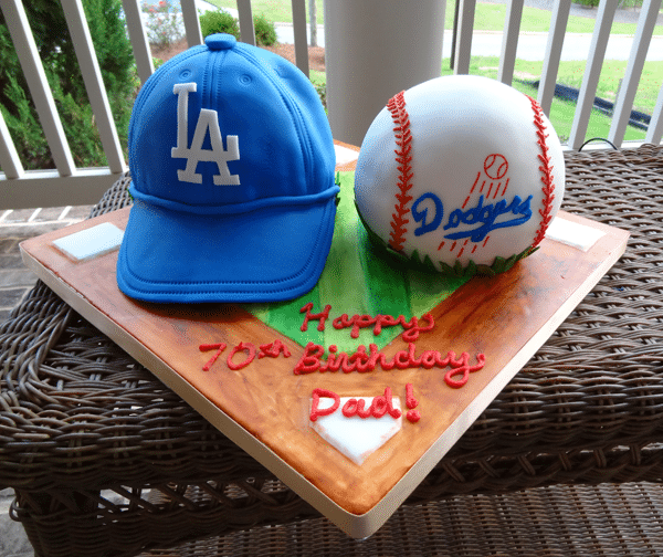 An LA Dodgers Hat Cake and Baseball Cake on a Baseball Field Cake Stand