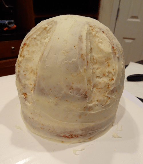 The Circular Hat Cake Base with a Crumb Coat of White Frosting