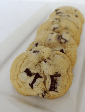 Five New York Times Chocolate Chip Cookies Lined up on a Plate