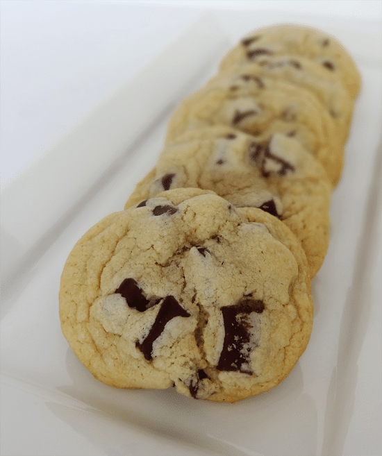 Five New York Times Chocolate Chip Cookies Lined up on a Plate