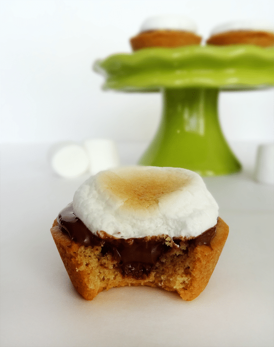 A Peanut Butter Nutella Cup with Marshmallow on top and a bite missing