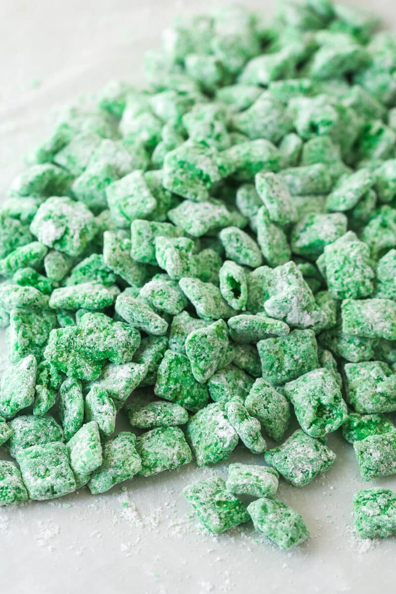 green chex covered in powdered sugar pilled onto table