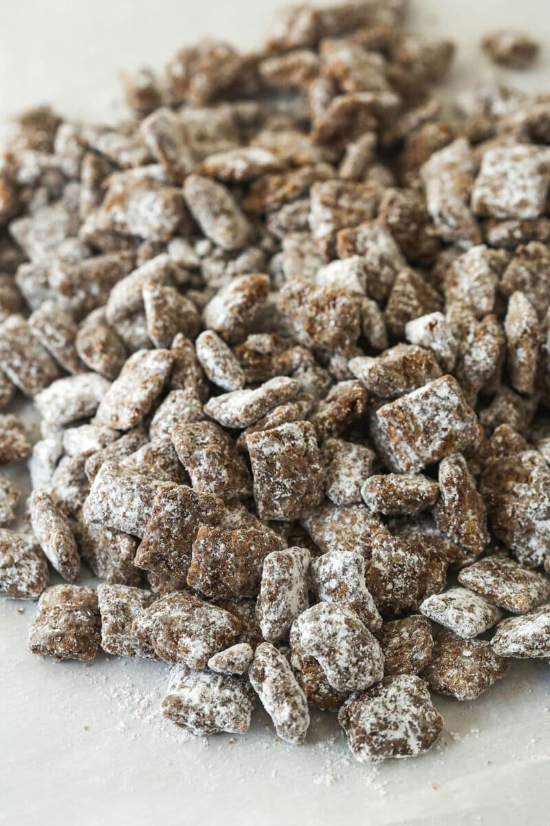 chocolate chex covered in powdered sugar spilled onto table