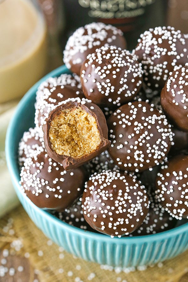 A large bowl full of Baileys no-bake cookie balls decorated with white nonpareil sprinkles
