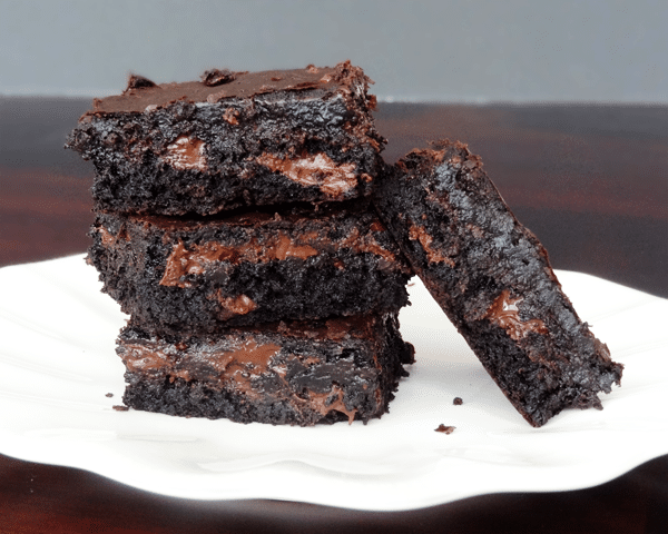 Moist and Chewy Brownies stacked on a white plate