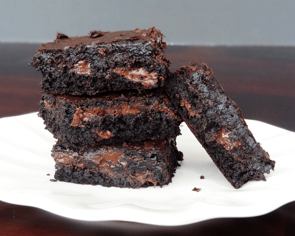 Four fresh Brownies on a white plate