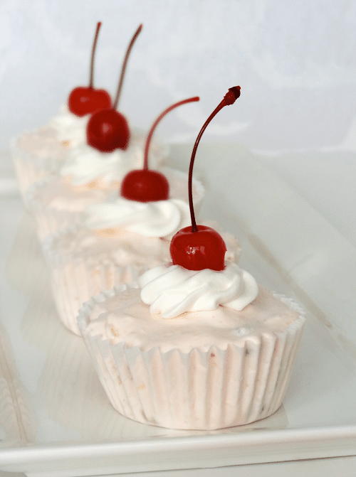 A white platter with Frozen Fruit Salad Cupcakes in a line