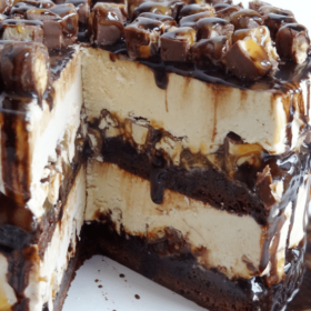 A Snickers Ice Cream Layer Cake with Two Slices Removed