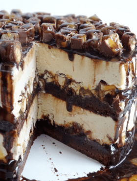 A Snickers Ice Cream Layer Cake with Two Slices Removed