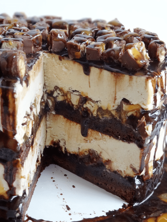 Snickers Peanut Butter Brownie Ice Cream Cake A Snickers Ice Cream Layer Cake with Two Slices Removed