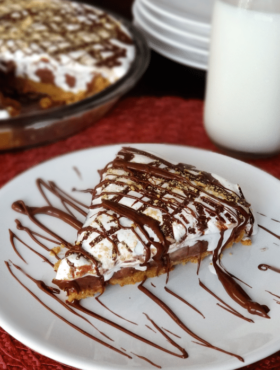 A slice of Nutella, Peanut Butter and Marshmallow Pie on a white plate