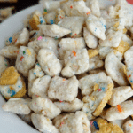 Golden Birthday Cake Oreo Puppy Chow in white bowl close up