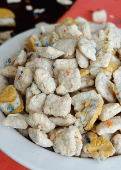 Golden Birthday Cake Oreo Puppy Chow in white bowl close up