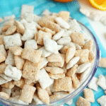 Orange Creamsicle Puppy Chow in glass bowl