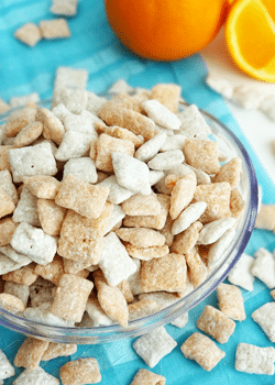 Orange Creamsicle Puppy Chow in glass bowl