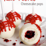 A Red Velvet Cheesecake Pop with a Bite Taken Out to Reveal the Red Velvet Cake and Cheesecake Inside