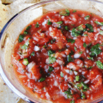 Roasted Tomato Salsa in clear bowl surrounded by chips