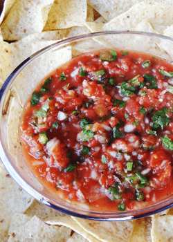 Roasted Tomato Salsa in clear bowl surrounded by chips