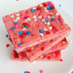 Valentine' Strawberry Cream Cheese Bars stacked on white plate