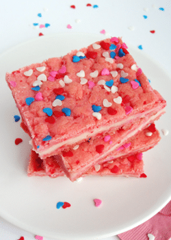 Valentine' Strawberry Cream Cheese Bars stacked on white plate