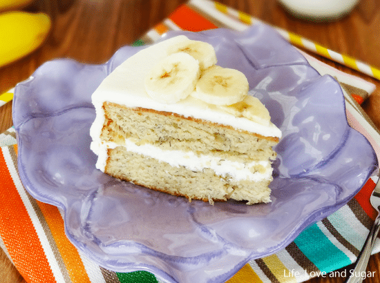 A slice of banana cake on a purple plate made out of clay