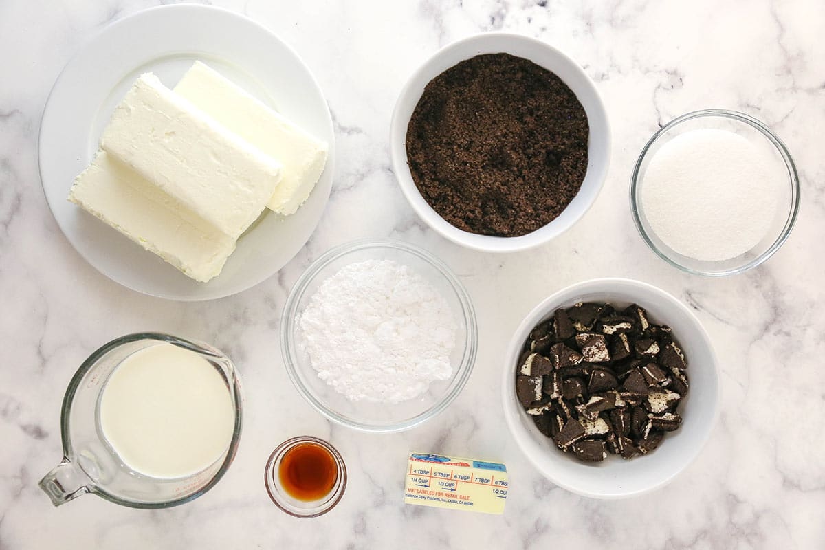 Ingredients for Oreo cheesecake on a marble counter