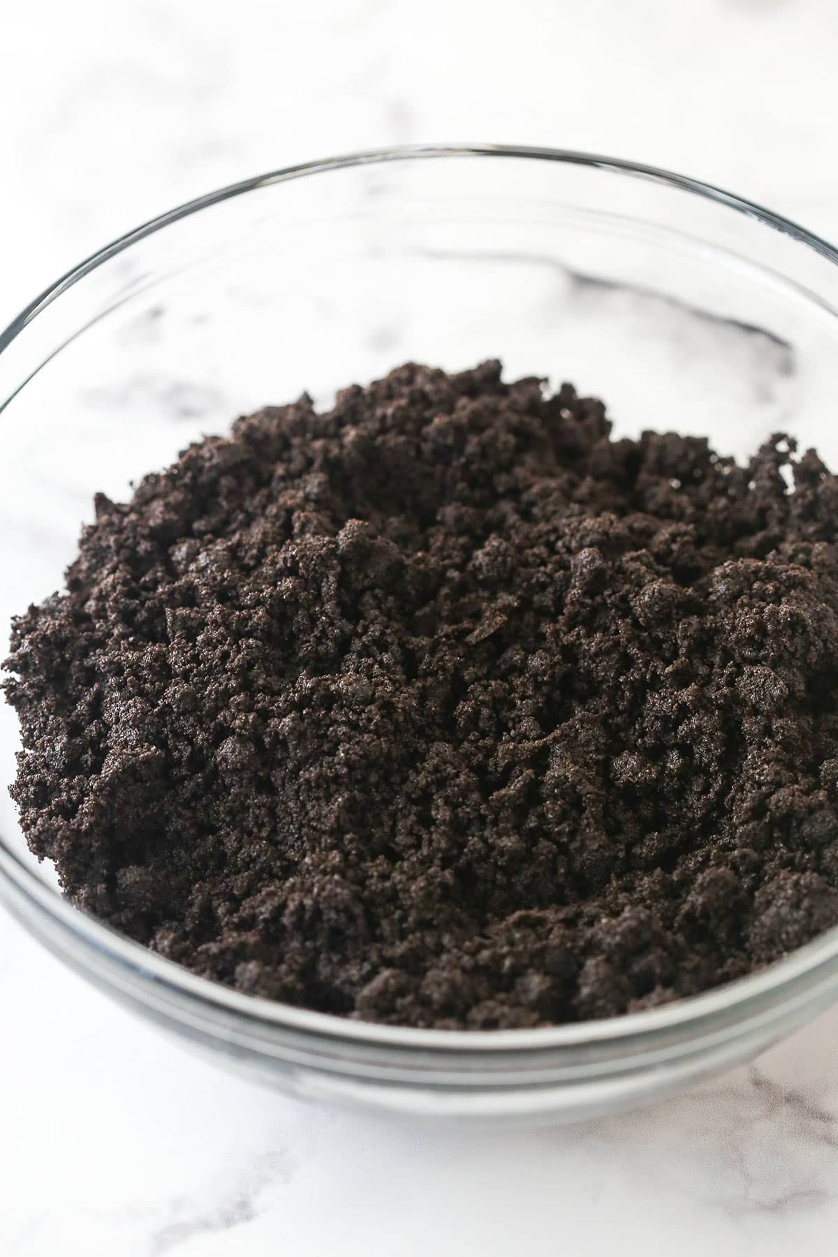 Crushed Oreo cookies in a glass bowl