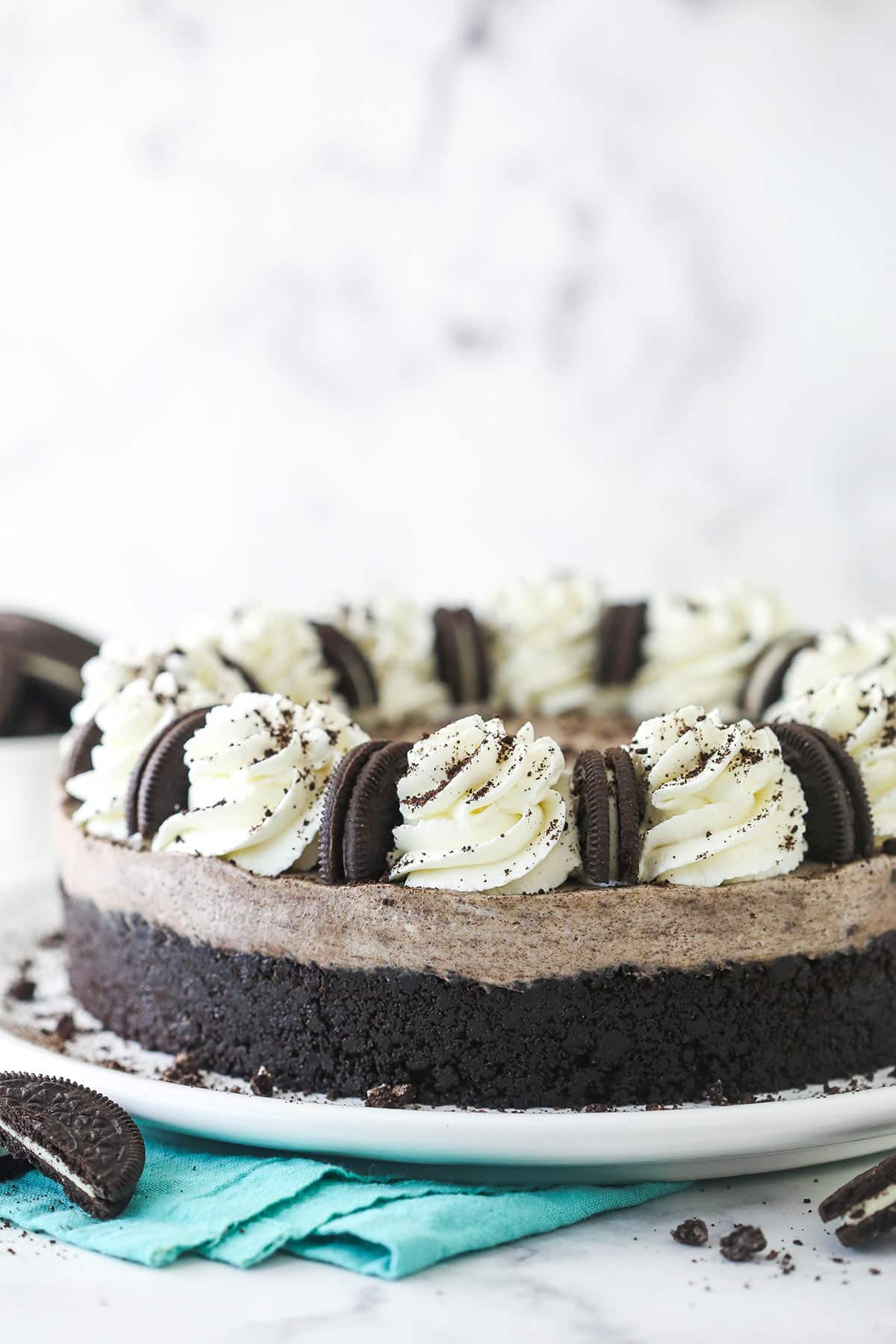 An oreo cheesecake on a cake stand