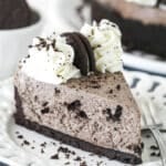 A slice of no bake oreo cheesecake on a white plate