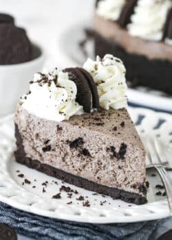 A slice of no bake oreo cheesecake on a white plate