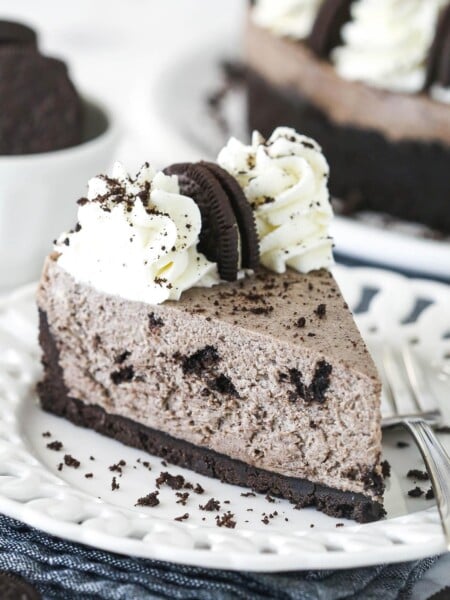 A slice of no bake oreo cheesecake on a white plate
