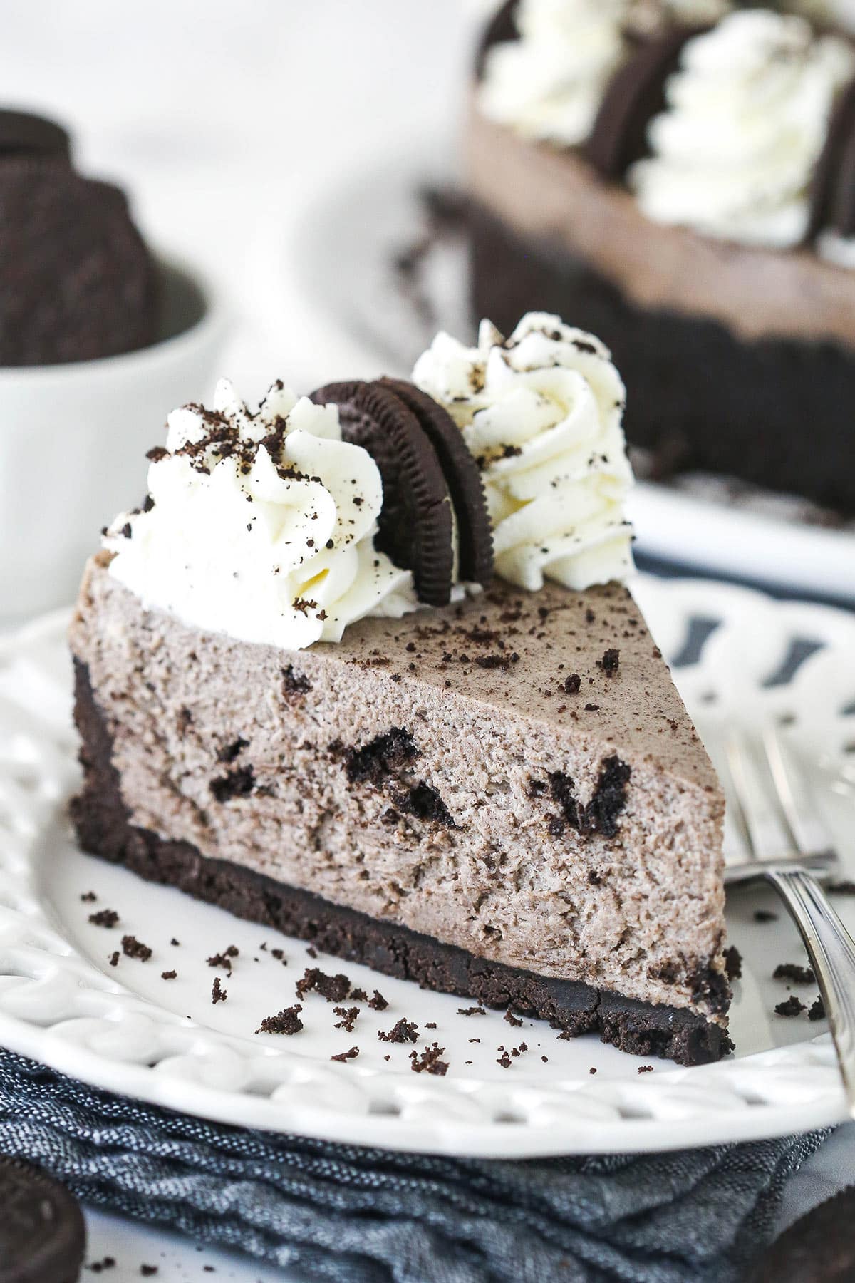 A slice of no bake oreo cheesecake on a white plate