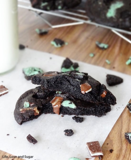 Two Mint Chocolate Cookies with bites missing showing melting Andes Mints inside 