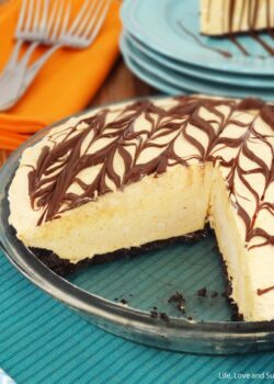 A Nutella ice cream pie in a glass pie dish with two slices removed