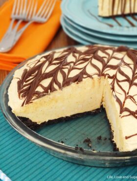 A Nutella ice cream pie in a glass pie dish with two slices removed