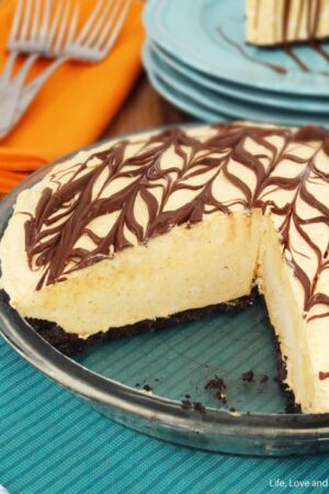 A Nutella ice cream pie in a glass pie dish with two slices removed