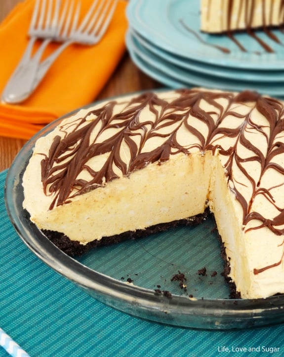 A Nutella ice cream pie in a glass pie dish with two slices removed