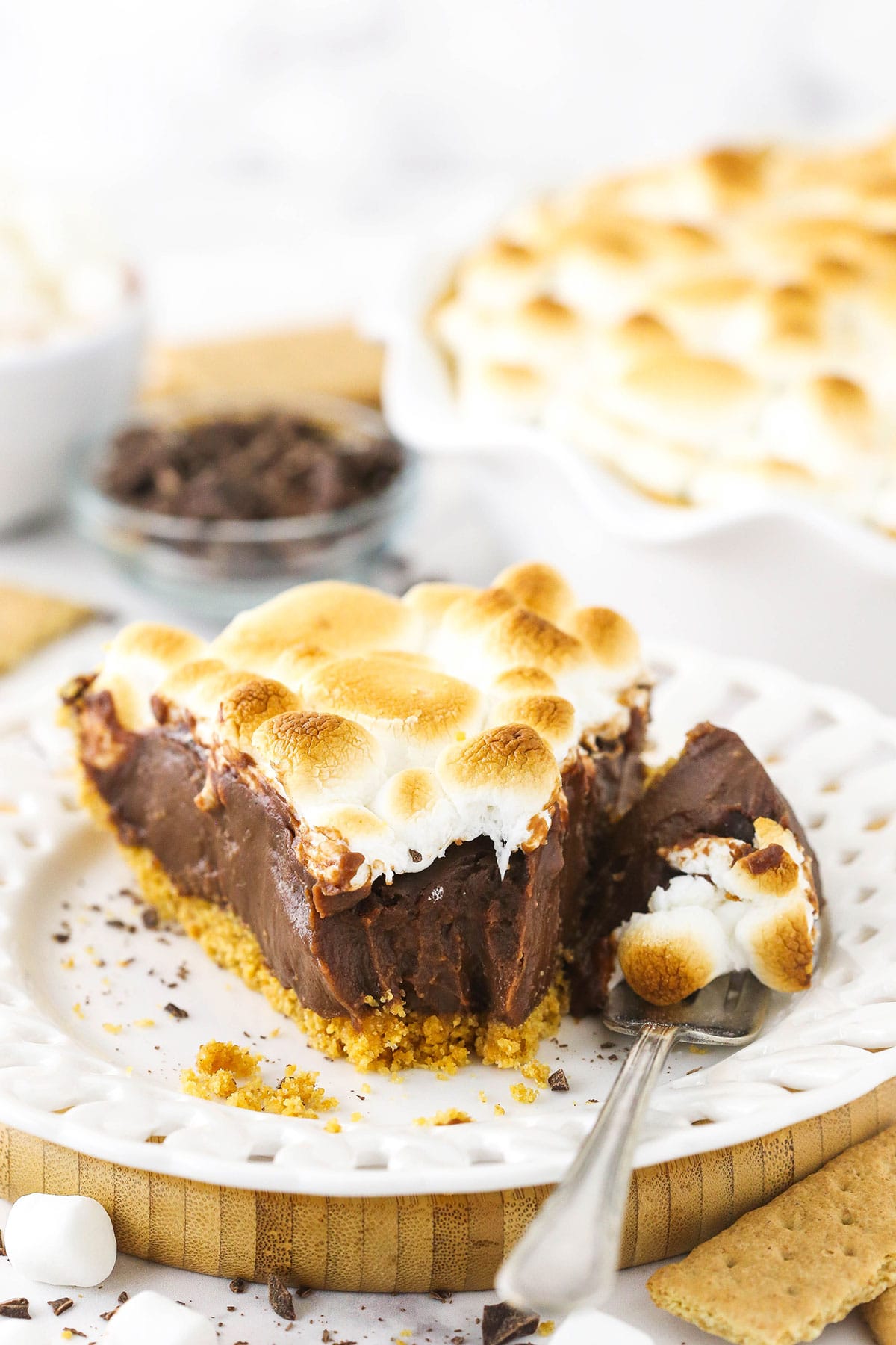 A slice of smore's chocolate pie with a bite taken out