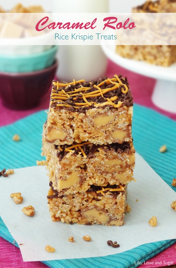 Three square Caramel Rolo Rice Krispie Treats stacked on white paper
