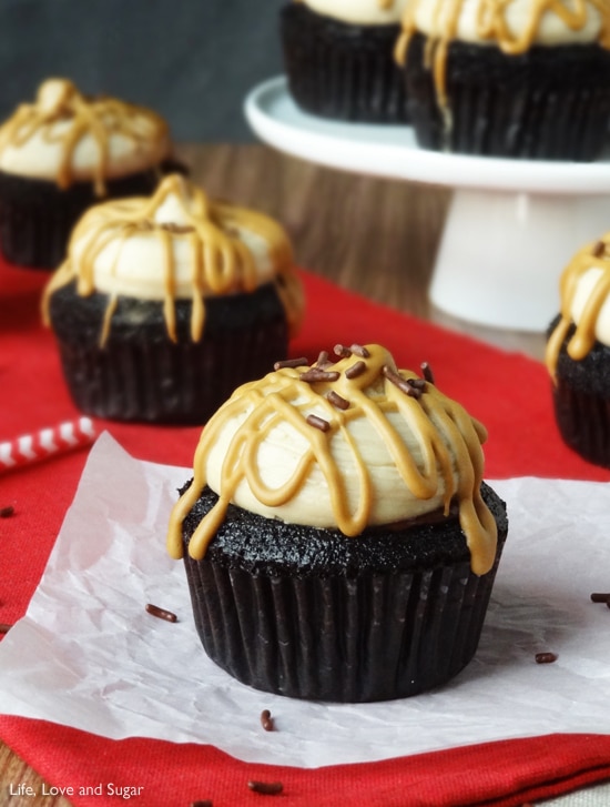 A Caramel Macchiato Chocolate Nutella Cupcake on a white paper with sprinkles