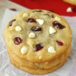 Cranberry white chocolate chip cookies stacked close up